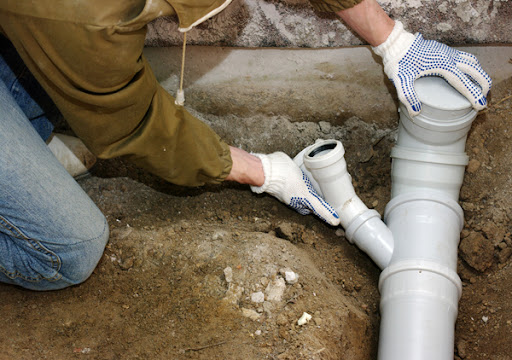 "Sewer line backup and drainage blockage causing wastewater overflow in a building plumbing system."